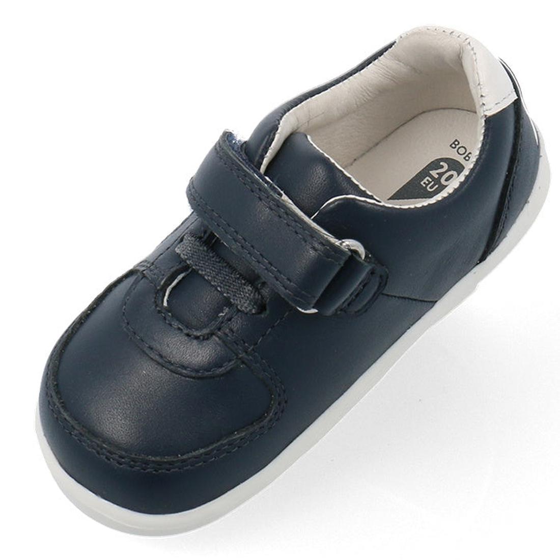 The Bobux Step Up SU Toddlers Leather Sneaker Comet Navy 734603 is a single navy kids sneaker with a hook-and-loop strap, flexible white sole, white inner lining, and visible stitching, shown from above., 9420075706248, 9420075706255, 9420075706262, 94200