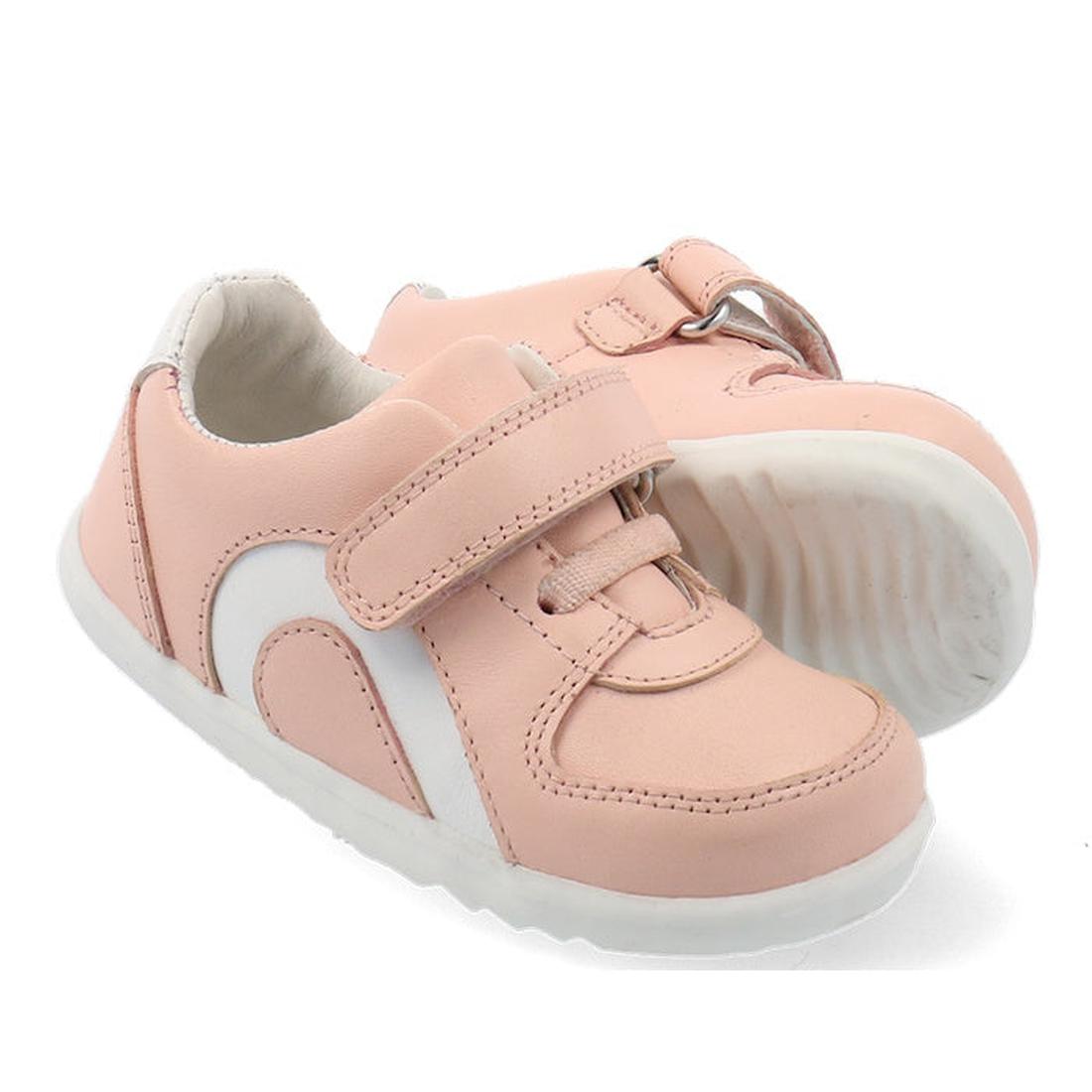 The Bobux Step Up SU Toddlers Leather Sneaker Comet Pink 734604 features light pink leather, a flexible sole, and hook-and-loop straps. One shoe is positioned in front at an angle, with the other slightly behind.