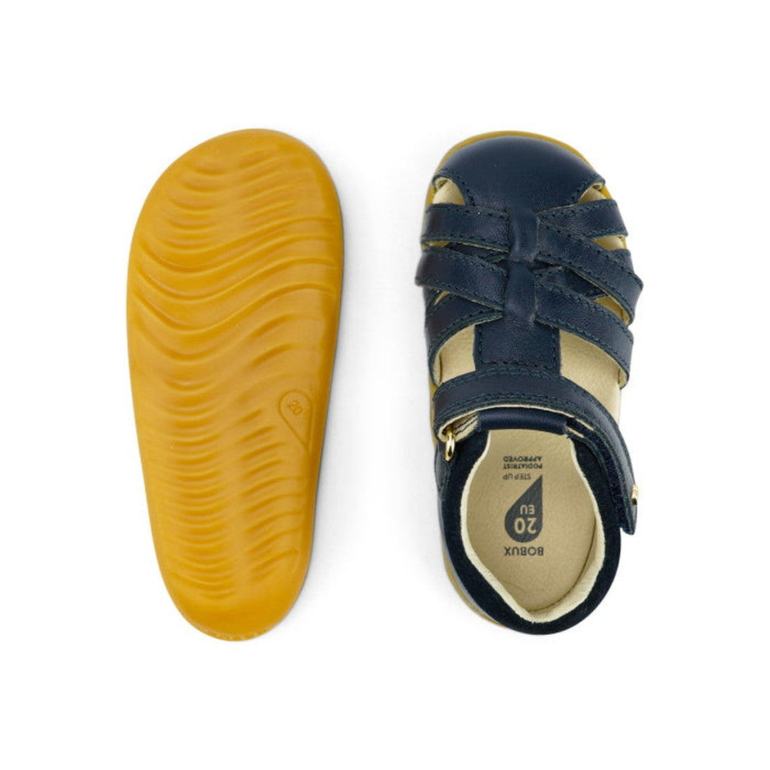 A pair of Bobux Step Ups Cross Jump Navy Closed Toe Sandal unisex; one shoe displays dark blue straps and a beige interior from the top, while the other shows its flexible, textured yellow sole from the bottom., 9420062083567, 9420062083574, 9420062083581