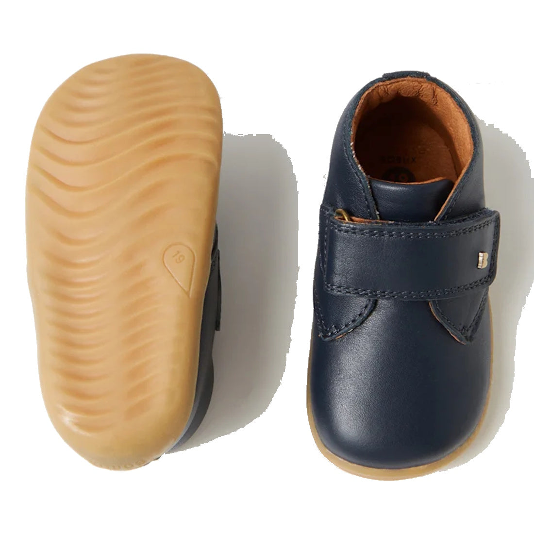 A pair of navy blue Bobux Step Up Desert Boots showing the top down view of one foot and the sole of the other.,9420062061213, 9420062056219, 22098
