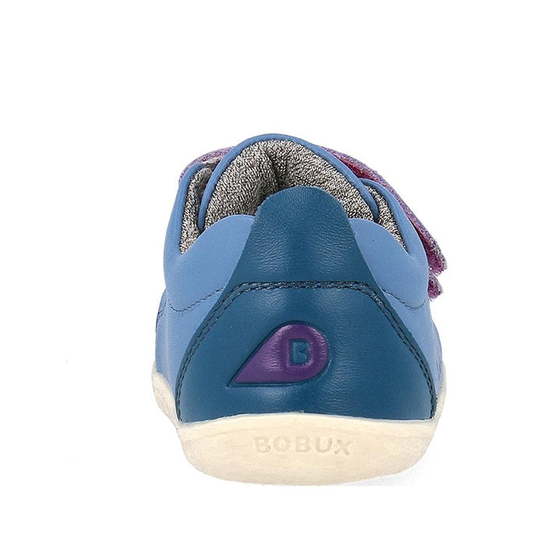 The Bobux Step Up Grass Court Trainer Elemental Blue 734205 is a toddler shoe in blue, seen from the back with a purple B logo on the heel, BOBUX printed on the white sole, and a premium leather upper., 9420075773202, 9420075768741, 9420075771147, 9420075