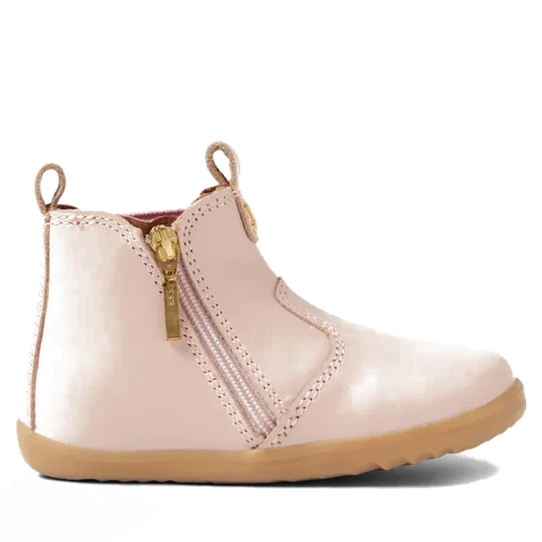 The Bobux Step Up Jodhpur Boot Cameo Rose Pink is a light pink unisex leather toddler boot with a tan rubber sole, side zipper with gold pull, decorative stitching, and pull tabs—ideal as stylish first walkers., 9420068539471, 9420068539488, 9420068539495