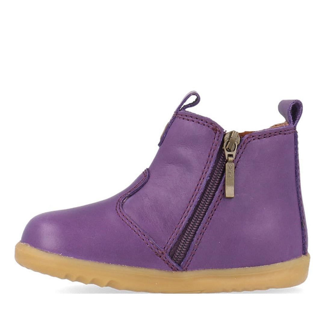 The Bobux Step Up Jodphur Boot Indigo Purple is a unisex toddler boot in purple leather with a tan rubber sole, side zipper, and front/back pull tabs—ideal for first walkers and shown in profile to display the outer zipper detail., 9420075788879, 94200757