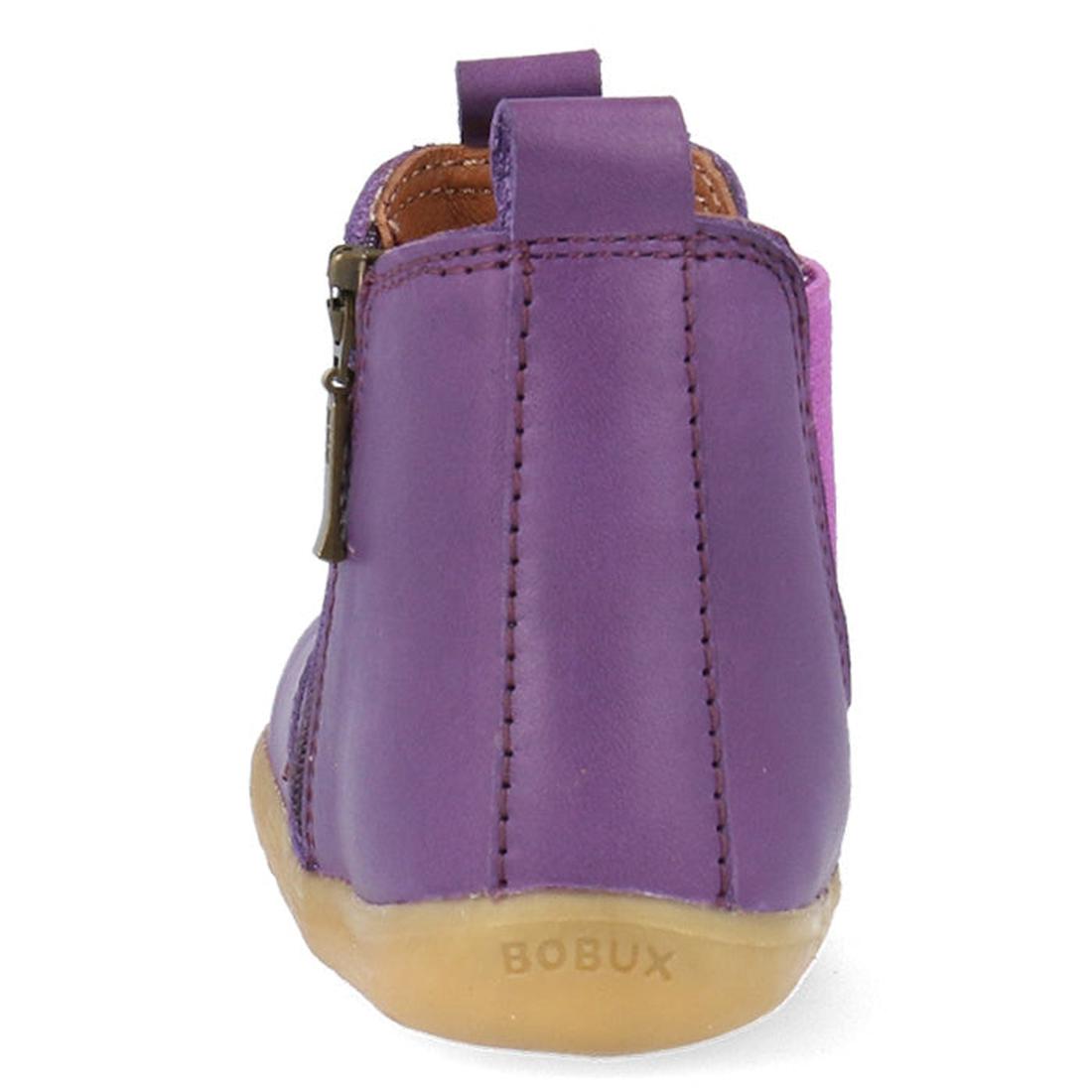 The Bobux Step Up Jodphur Boot Indigo Purple is a unisex children's boot in purple leather, seen from the back, with brown stitching, a side zipper, light brown sole embossed "BOBUX" on the heel—perfect for first walkers., 9420075788879, 9420075789456, 94