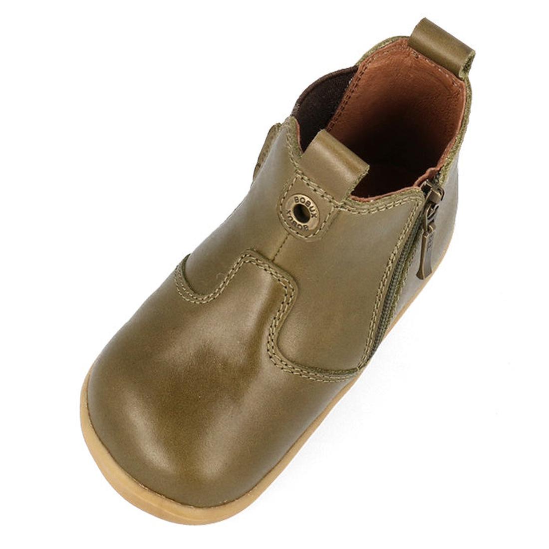 The Bobux Step Up Jodphur Boot Olive 721960 is a single unisex first walker in olive green leather with a tan rubber sole, side zipper, brown lining, and decorative stitching, shown from above at an angle., 9420075796300, 9420075796126, 9420075796430, 942