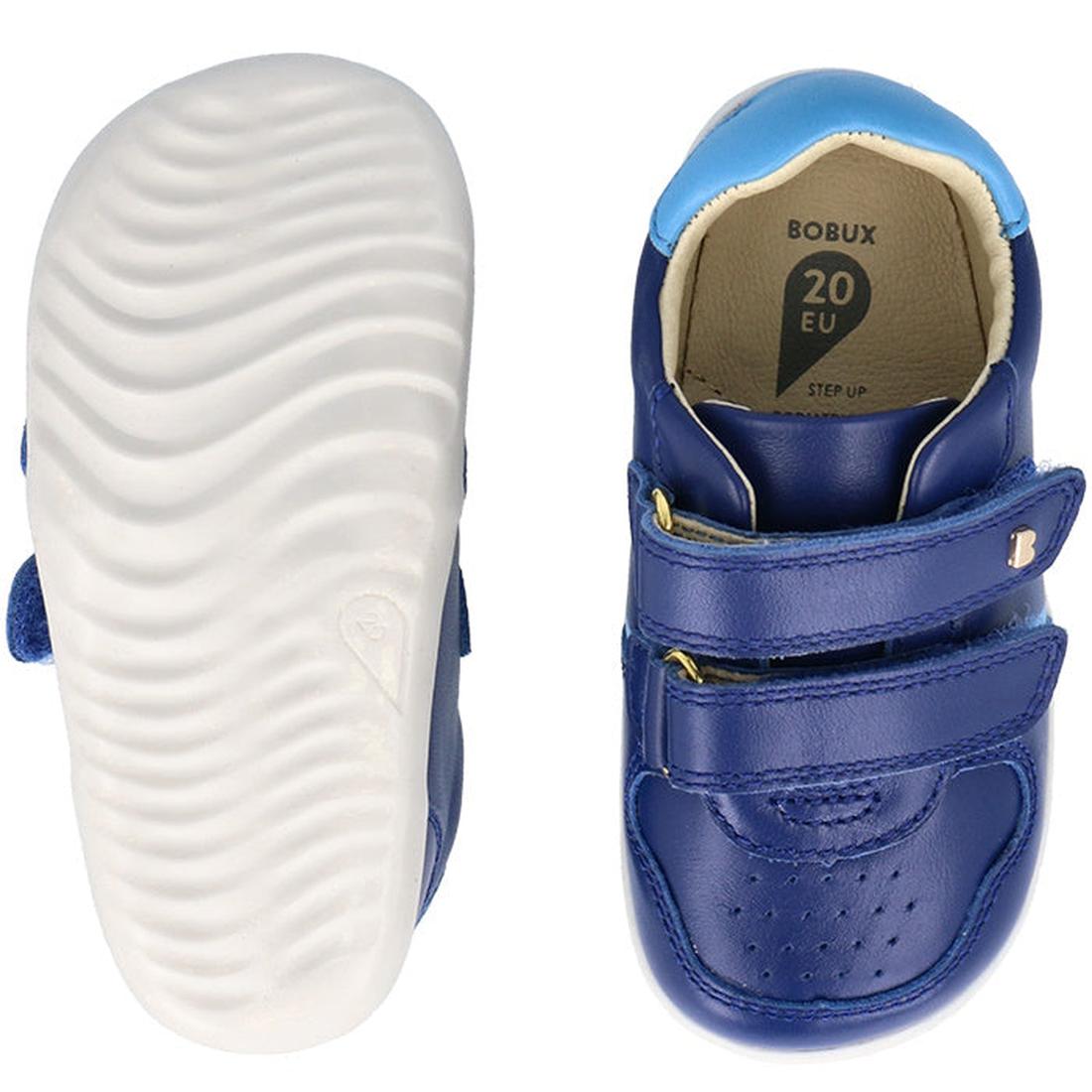 Two views of the Bobux Step Up SU Riley Sneaker Blueberry for toddlers: one top view and one bottom, showing its white wavy sole. Made with vintage-look leather and double strap closures, this unisex style comes in size EU 20., 9420075794962, 942007579486