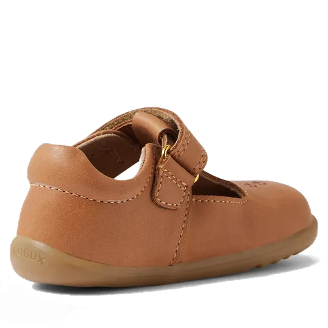 The Bobux Step Up T-Bar Rosie First Walker Shoe in Caramel Tan is a toddler leather flat with a hook-and-loop strap, flexible rubber sole, and BOBUX embossed on the heel—perfect for first walkers, shown from the back-left angle., 51165, 9420074850041, 942
