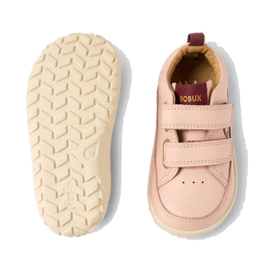 The Bobux SU Step Up Dawn Leather Boot in Cameo Rose Pink Alpha is a pair of pink barefoot shoes for first walkers, featuring two velcro straps, chevron-patterned cream-colored soles, and a maroon and gold BOBUX label on the tongue., 9420068578821, 942006