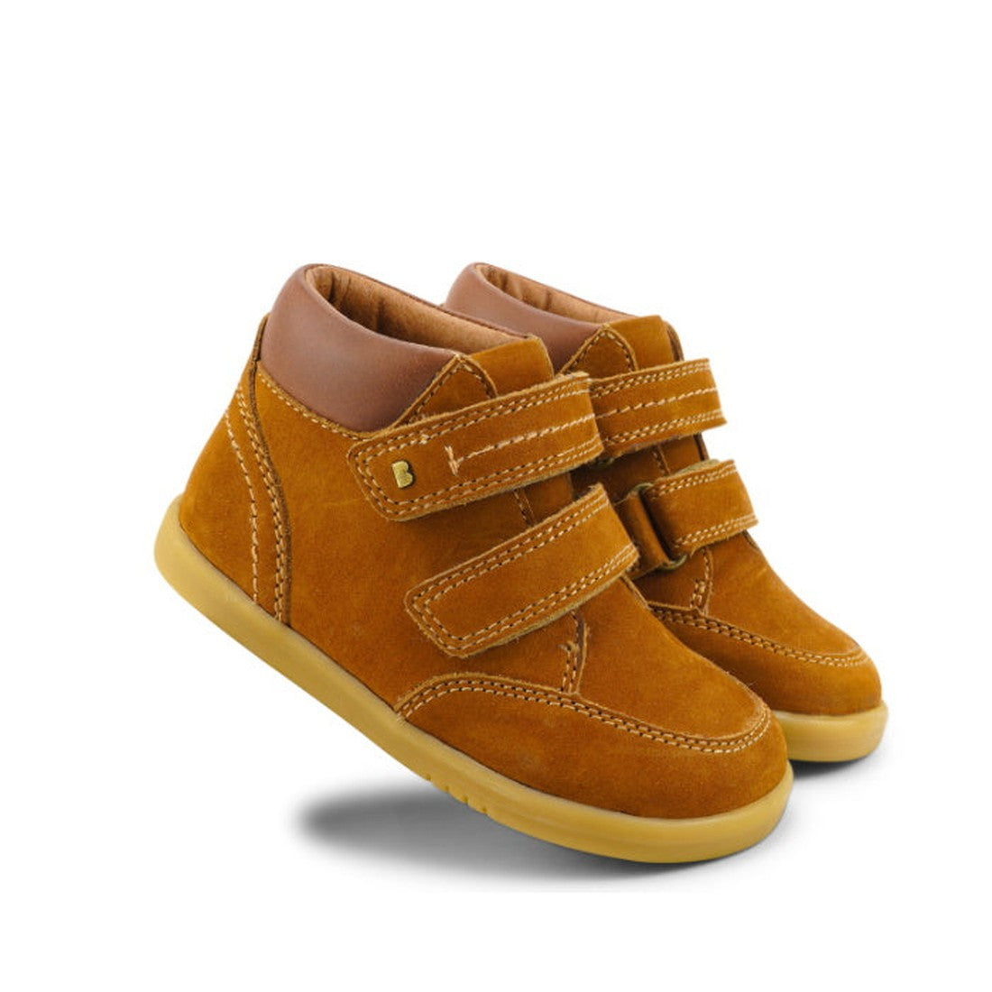 The Bobux Iwalk Timber Mustard Leather Boot - 632618, a children's leather boot with Velcro straps, tan rubber soles, and padded collars, is shown facing slightly right against a white background.