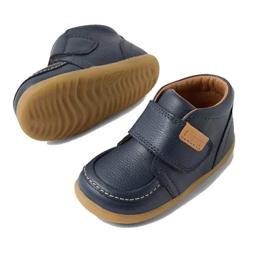 The Bobux Step Up First Walkers Grover Leather Boot in navy features tan rubber soles, white stitching, and velcro straps—ideal for first steps and shown on a white background., 9420074831750, 9420074831767, 9420074831774, 9420074831781