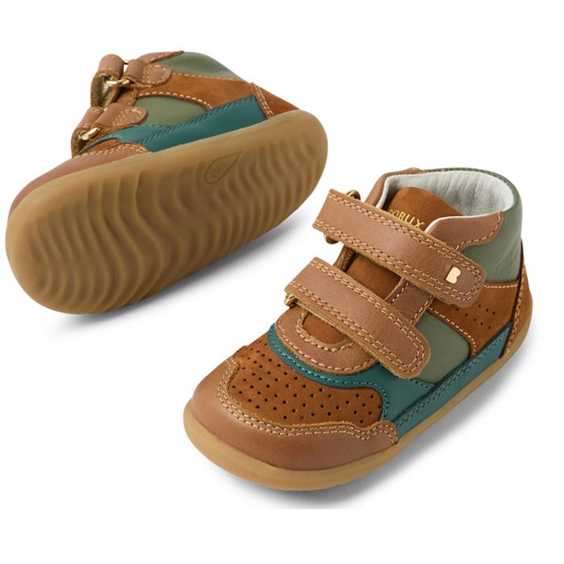 The Bobux SU Harley First Walker Leather Boots Tan are toddler boots with brown, tan, green, and teal leather panels, velcro straps, and rubber soles. One boot stands upright while the other displays its textured sole., 9420074833266, 9420074833273, 94200
