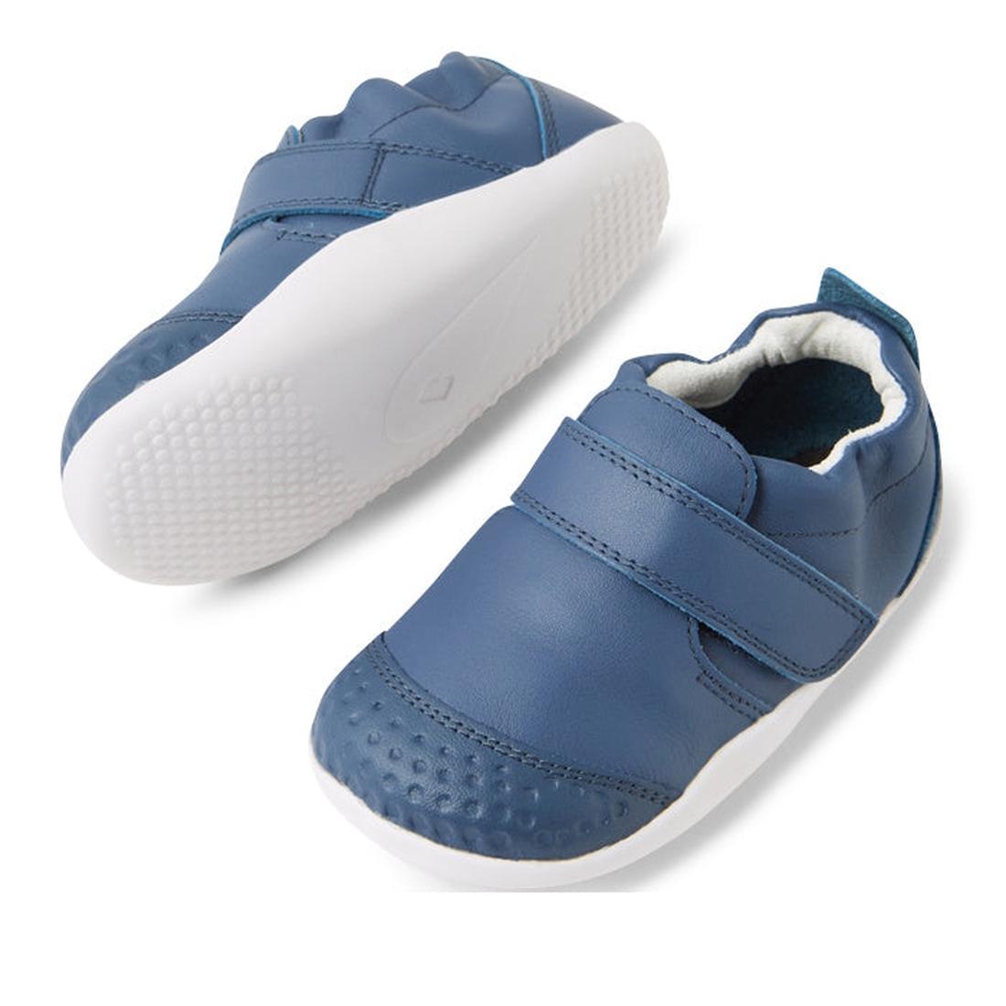 The Bobux XP Xplorer First Walking Shoes Go Vintage Indigo Blue are toddler pre-walker leather shoes with flexible soles, white edges, a single velcro strap, and textured toes, shown from the side and top on a white background., 9420074842657, 94200748426