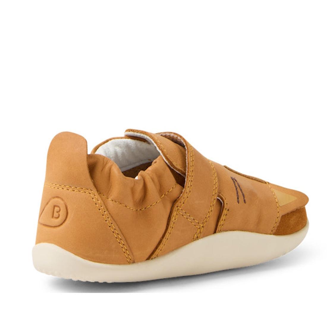 The Bobux XP Xplorer Rummage First Walking Shoes in Pumpkin Spice Orange feature a flexible EVA sole, elasticized heel, and velcro strap, shown angled from the back—perfect pre-walker shoes for toddlers., 9420074805904, 9420074805911, 9420074805928, 94200