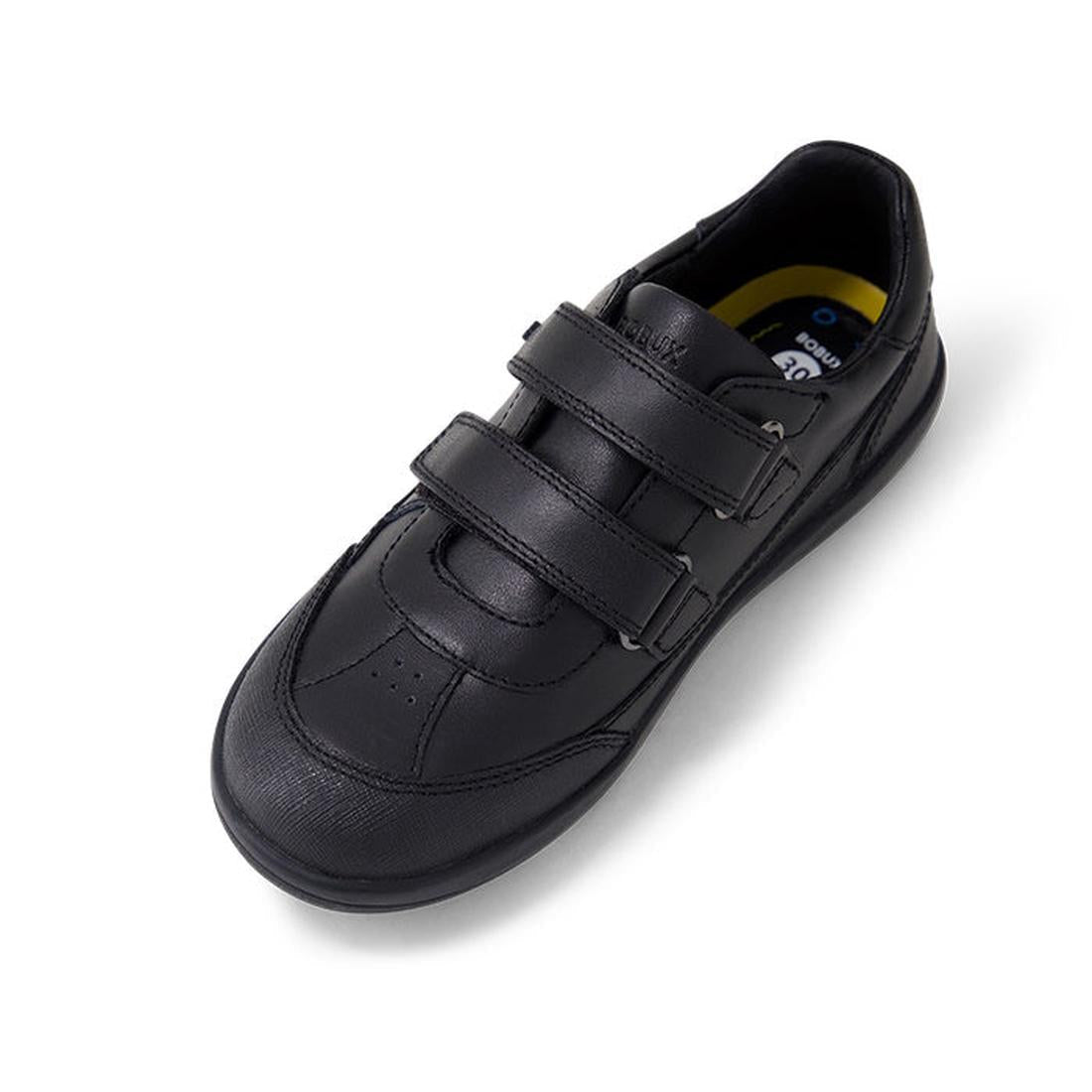 The Bobux Kid+ Black School Leather Shoe Traverse Trainer is a single black leather sneaker with two Velcro straps, a rounded toe, and cushioned insole. The durable kids’ shoe is angled on a white background., 9420075762978, 9420075762985, 9420075762992, 