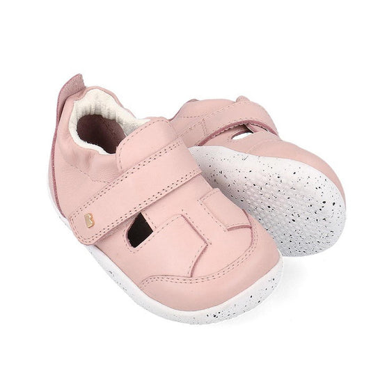 The Bobux XP Explorer Breeze First Walker Sandal Rose Water Pink 502405 features light pink, breathable cutout uppers, soft material, white textured flexible soles, and secure Velcro straps for comfort and support.