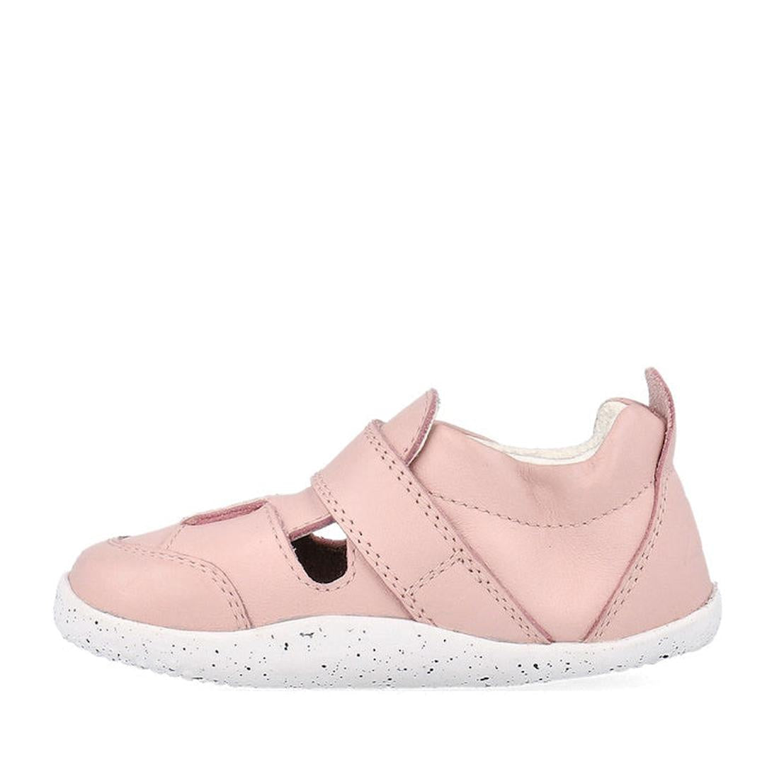 The Bobux XP Explorer Beau First Walker Sandal in Blossom Pink 502305 features cut-out sides, a Velcro strap, a light pink upper, white speckled flexible sole, and a heel pull tab; shown side view on a white background., 9420075785915, 9420075784284, 9420
