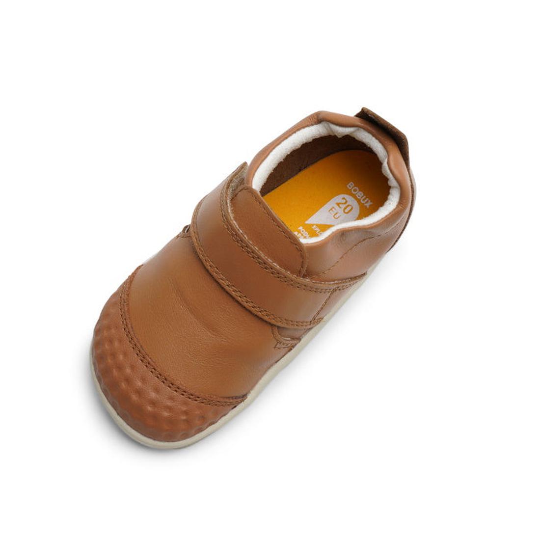 The Bobux Xplorer Go Caramel Tan First Walker 501037, a soft leather baby shoe with a hook-and-loop strap, rounded toe, and flexible textured sole, is shown from above on a white background., 9420071319039, 9420071319046, 9420071319053, 9420071319022