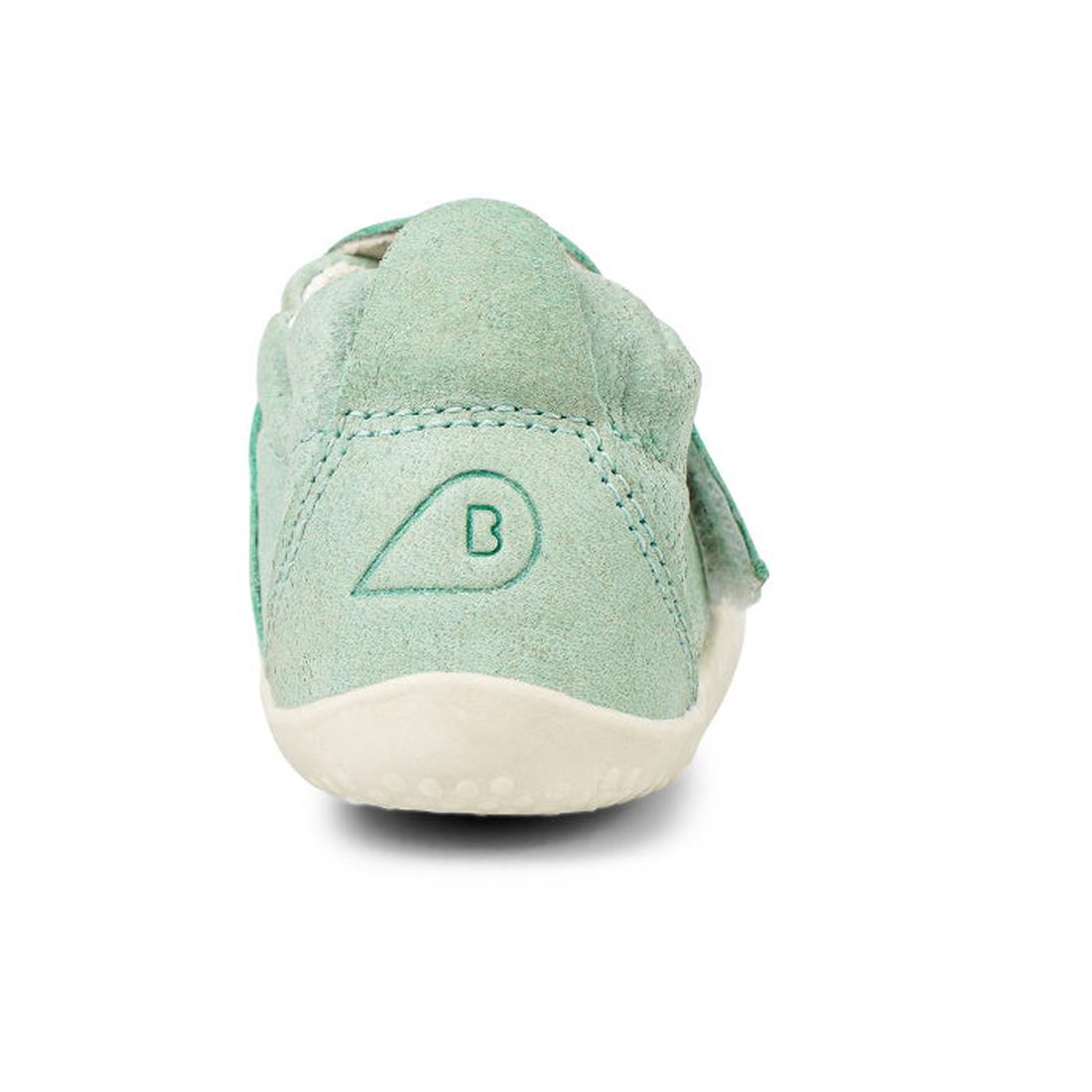 The Bobux XP Xplorer Marvel Mist Blue Dress Shoe First Walker 501227 is a mint green suede-like baby shoe with a flexible white sole and stitched B logo on the heel, shown from the back against a white background., 9420071309627, 9420071309634, 9420071309