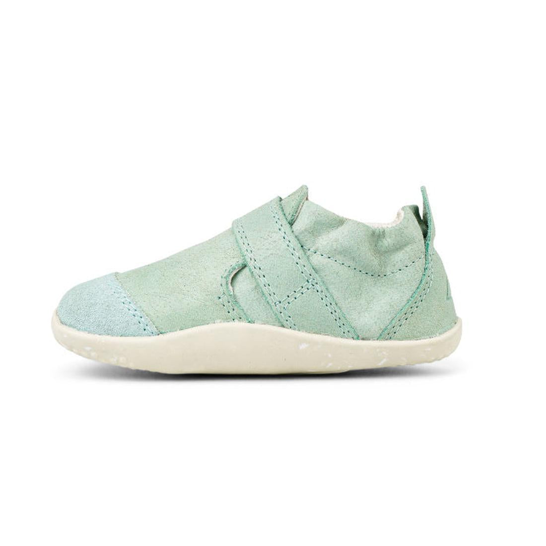 A single Bobux XP Xplorer Marvel Mist Blue Dress Shoe First Walker 501227 with a soft upper, closed toe, and a diagonal strap, shown in profile facing left against a white background., 9420071309627, 9420071309634, 9420071309641