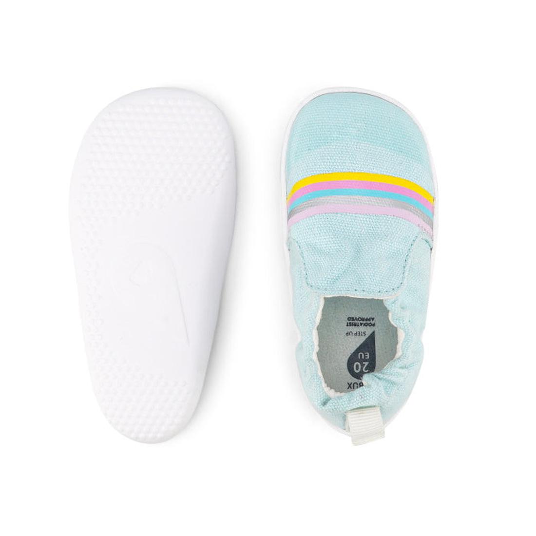 The Bobux Xplorer Scamp Crawler Aqua Silver Rainbow 501709 features a vegan-friendly light blue canvas upper with yellow, pink, and purple stripes, plus a white flexible sole—shown with one shoe top view and one bottom view., 9420068534384, 9420068534391,