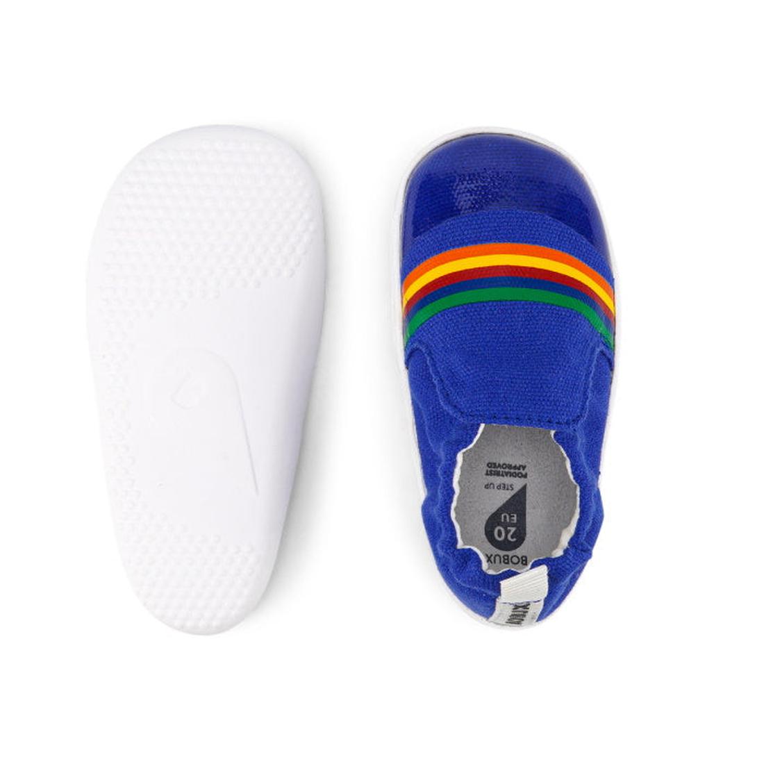 The Bobux Xplorer Scamp Crawler Blueberry Red Rainbow 501711 Canvas baby shoes feature a blue canvas upper with three rainbow stripes and a flexible, white textured rubber sole, shown from both above and below., 9420068534483, 9420068534490, 9420068534506