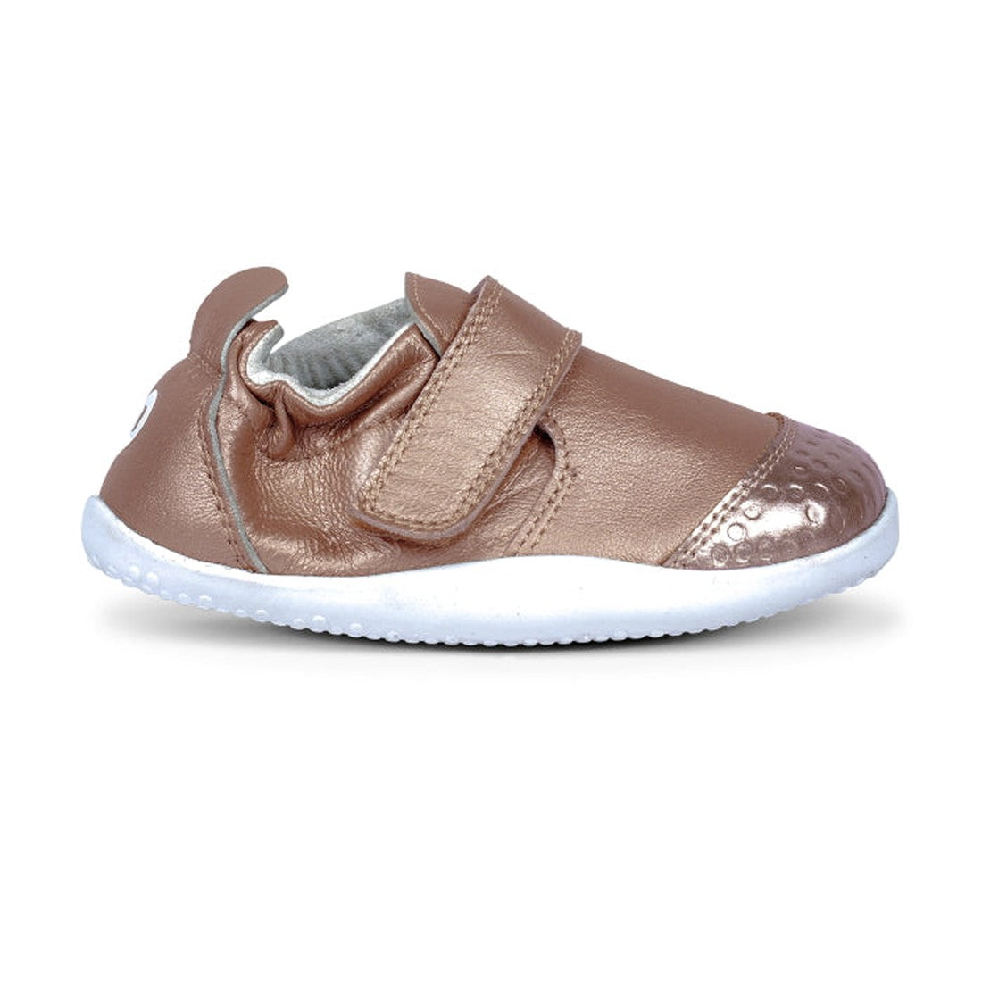 The Bobux Explorer Go Rose Gold First Walker Crawler 501015B features a white rubber sole, shiny metallic toe, velcro strap closure, premium soft leather-like material, flexible sole, and a pull tab at the heel., 9420075704473, 9420075704480, 942007570449