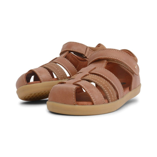 a pair of Bobux Kid+ Plus Roam Caramel Closed Toe Sandal 830506A- closed toe sandals with closed back for heel support. velcro around the heel and straps of leather over the toes so air can move freely around the toes.