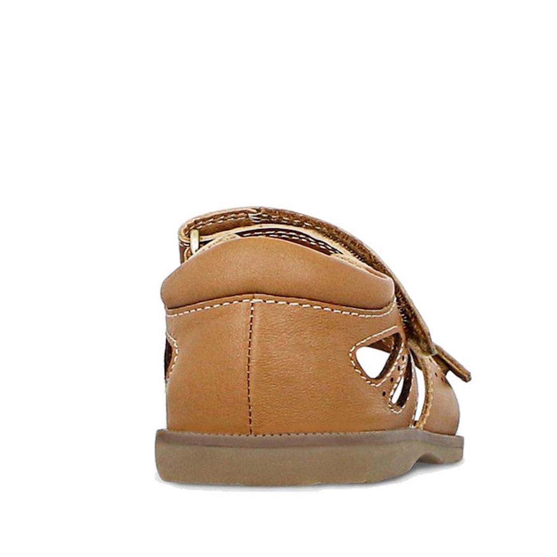 The Clarks Carrie Tan Leather Girls Sandal, shown from the back, features tan stitching, side cut-out details, and a flat rubber sole against a white background., 9336078210852, 9336078210890, 9336078210937, 9336078210975, 9336078211019, 39903, 39905, 399