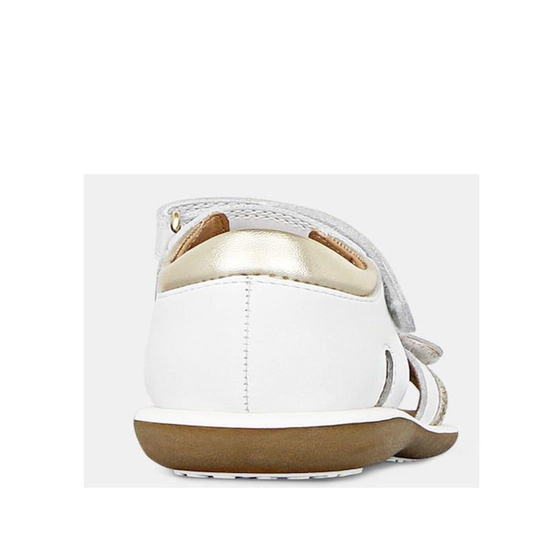 A close-up rear view of Clarks - Girls Pippa White Leather Sandals E, featuring a brown sole, gold accent on the heel, and white leather adjustable upper straps. The background is plain and light-colored., 9336078233325, 9336078233349, 9336078233363, 9336