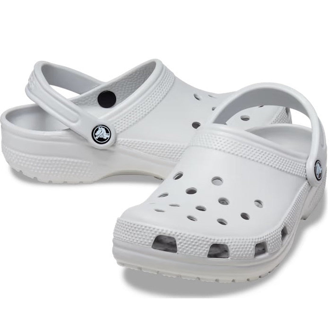 A pair of Crocs - Classic Clog Atmosphere Light Grey Adults, with ventilation holes and a pivoting heel strap, are shown on a plain background for lightweight comfort.