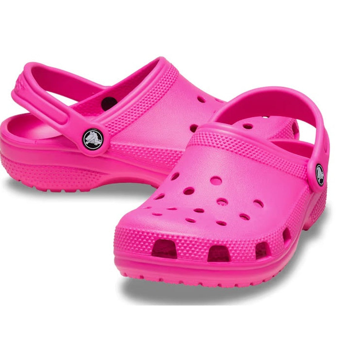 A pair of Crocs Kids - Classic Clog K Bright Pink Crush Toddlers, crafted from durable Croslite with ventilation holes and an adjustable heel strap, shown on a white background.