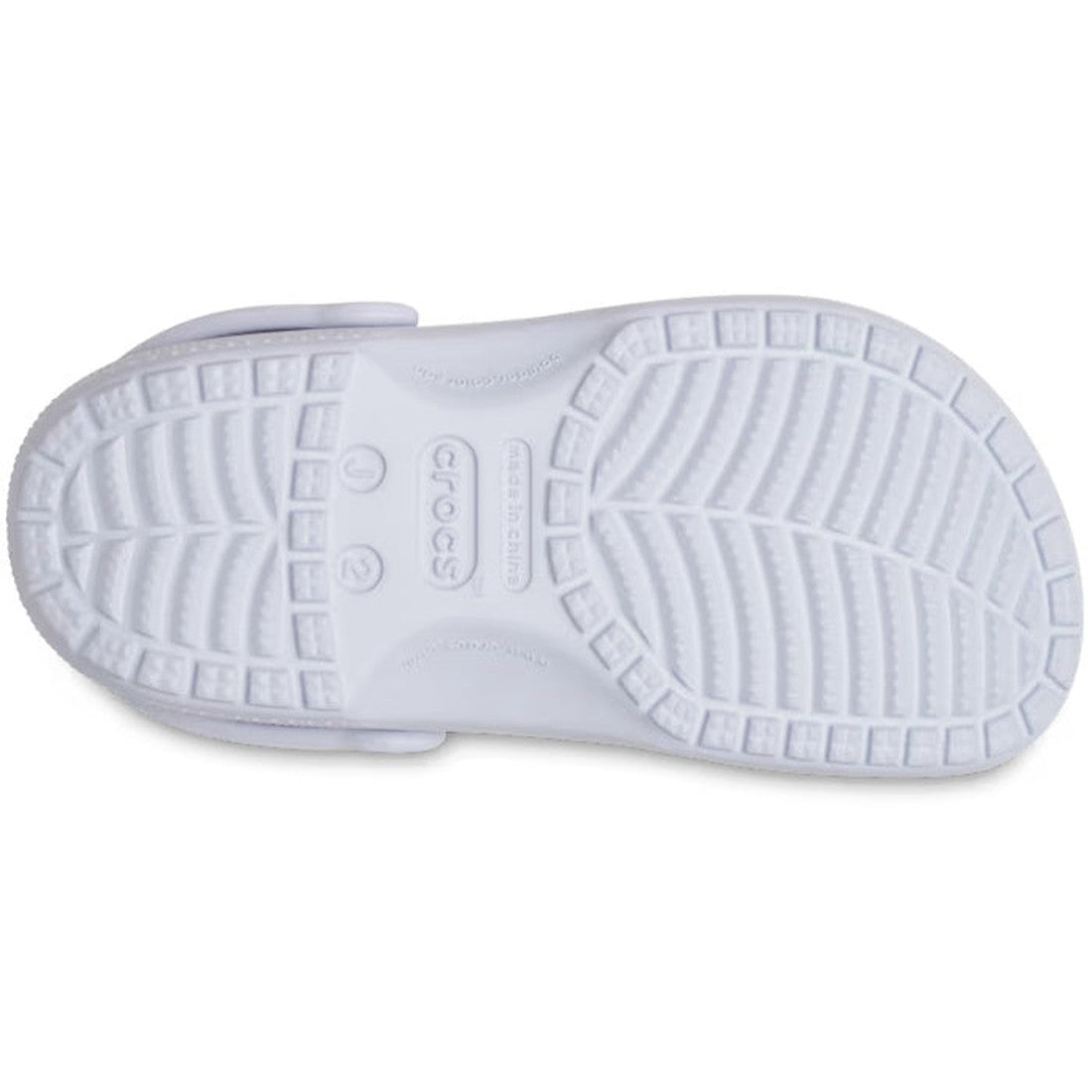 The image shows the bottom of a Crocs Kids - Classic Clog Dreamscape Purple, featuring a textured tread with linear and wavy grooves and a central Crocs logo. The sole delivers excellent grip for this junior youth water-friendly sandal., 196265549948, 196