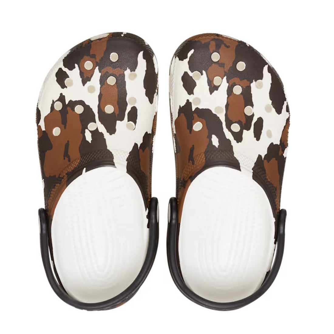 Crocs Kids - Youths Classic Clog K Cow Print White Sandals feature a playful brown, black, and white cow print, white soles, and black heel straps—a fun Western-inspired twist on classic clogs for kids., 196265869510, 196265869527, 196265869534, 196265869