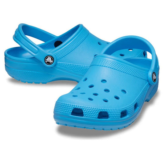 A pair of Crocs - Classic Clog Venetian Blue Adults with ventilation holes and adjustable heel straps is displayed on a white background.
