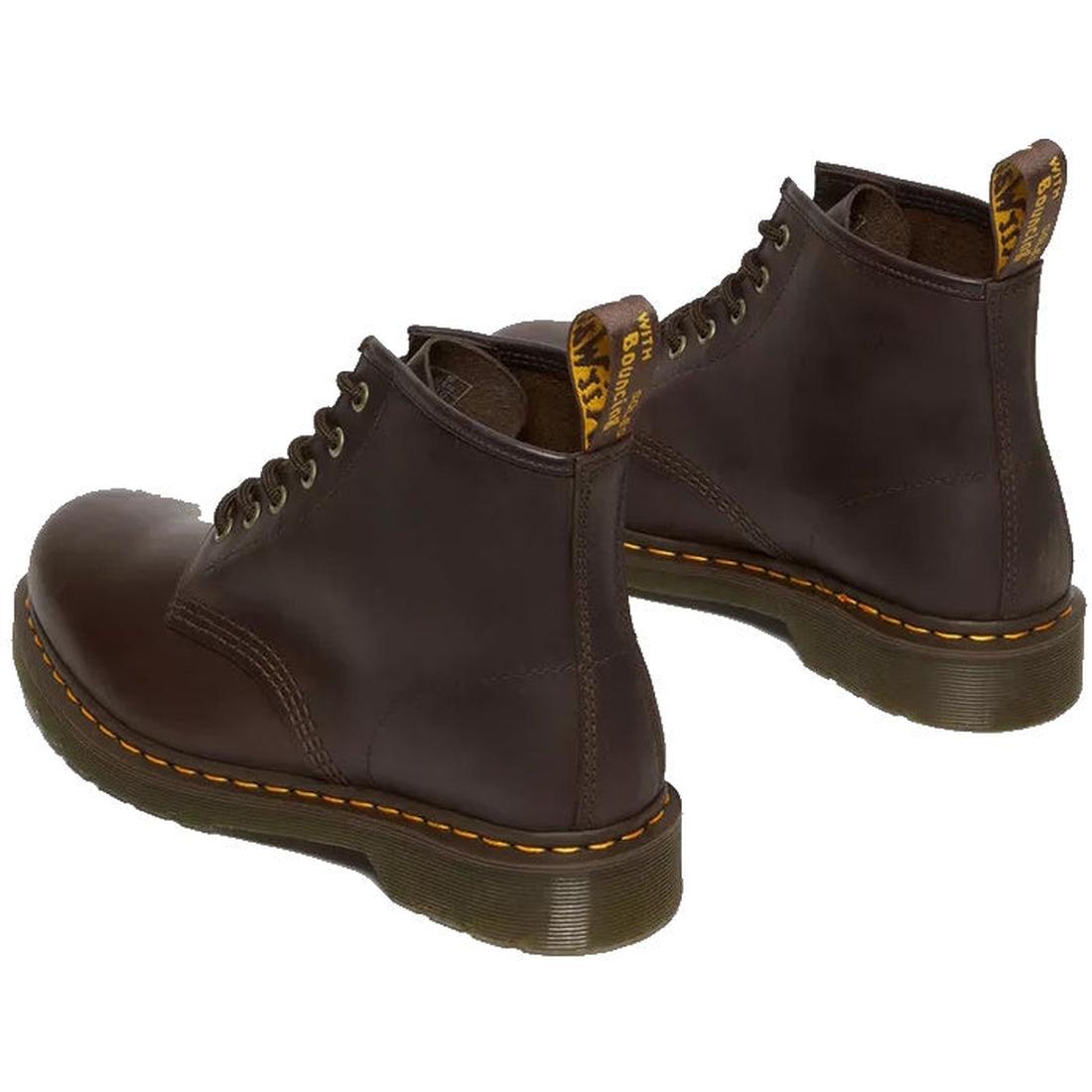 Th heel, rear view of a pair of brown leather  Dr Martens 101 6 eye boots with yellow stitching on a white background.,
190665488418,
190665488425,
190665488449,
190665488456,
190665488463,, 46217, 46218, 190665488418, 190665488425, 190665488449, 19066548