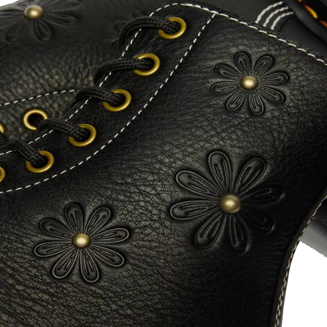 Close-up of black Grizzly leather on the Dr. Martens Women's 1460 Pascal Flower Boot, featuring decorative flower patterns, gold eyelets, and white stitching., 52216, 190665781137, 190665781144, 190665781151, 190665781175, 190665781182, 52222