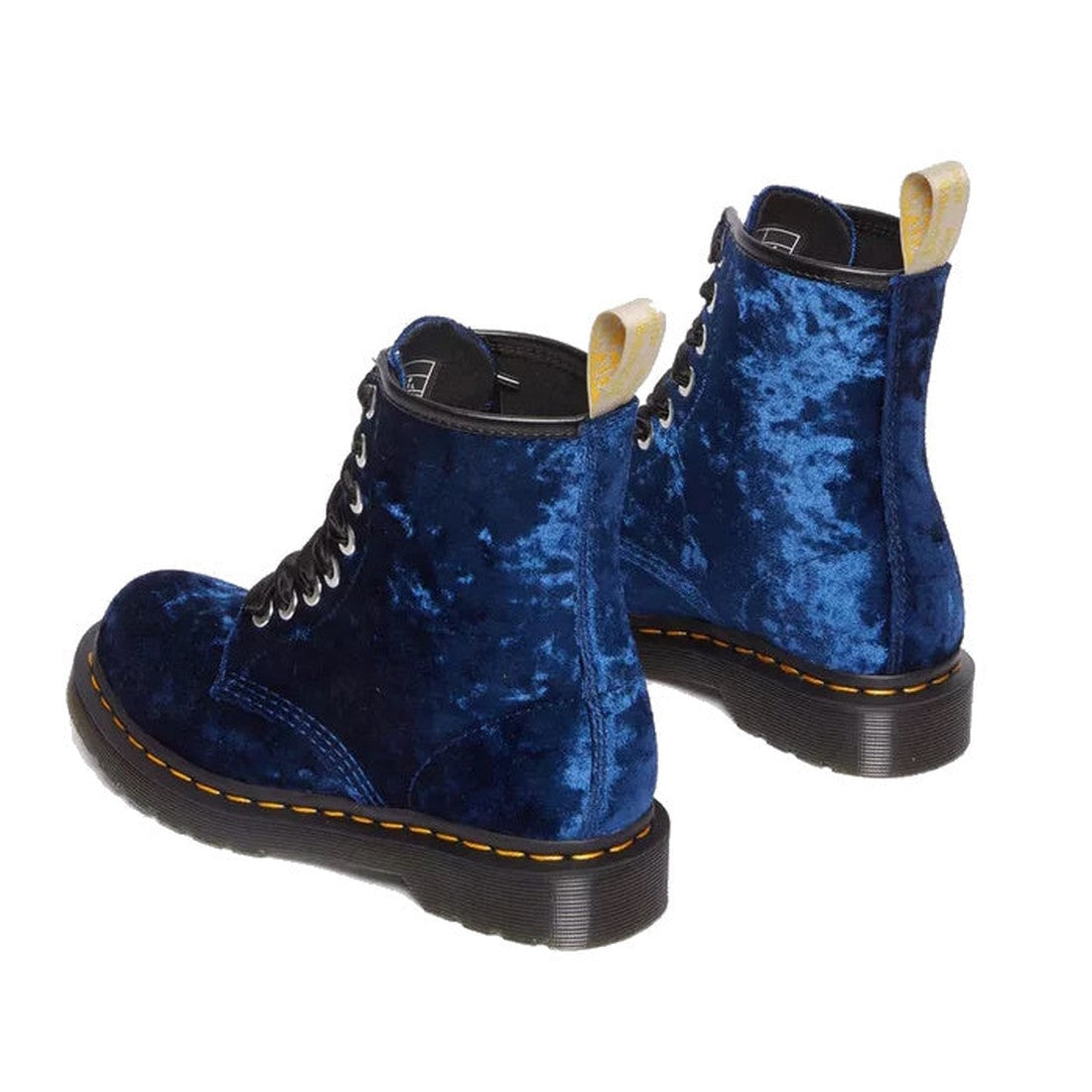 The Dr Martens 1460 Vegan Blue Crushed Velvet 8 Eye Boot features black soles, yellow stitching, black laces, and yellow pull tabs, shown on a white background., 190665581010, 190665581027, 190665581034, 190665581041, 190665581065, 190665581072