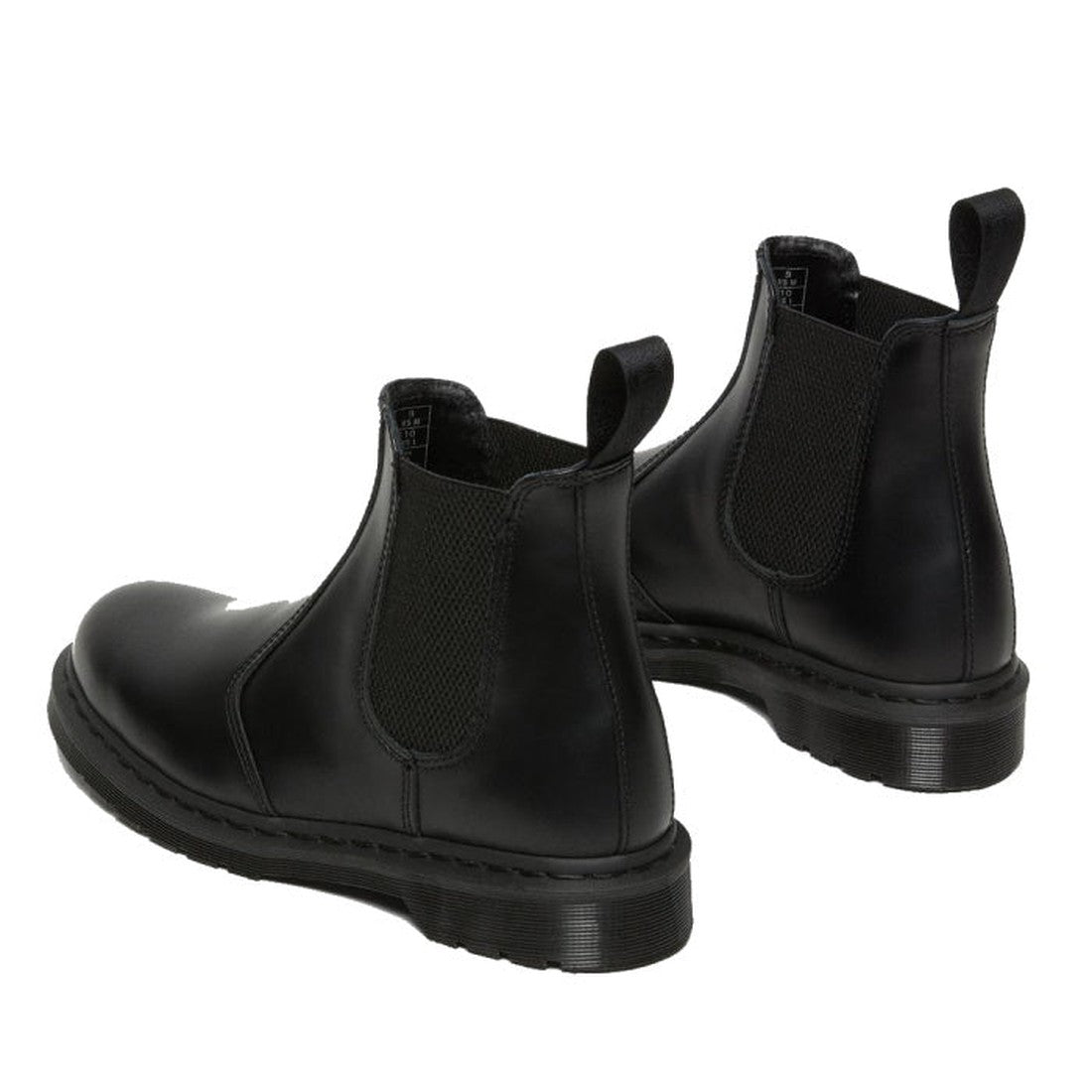 The Dr Martens 2976 Mono Black Chelsea Boot in smooth leather features elastic side panels, back pull tabs, and chunky rubber soles, shown from an angled rear view., 22760, 190665314717, 190665314724, 190665314731, 190665314748, 190665314755, 190665314762