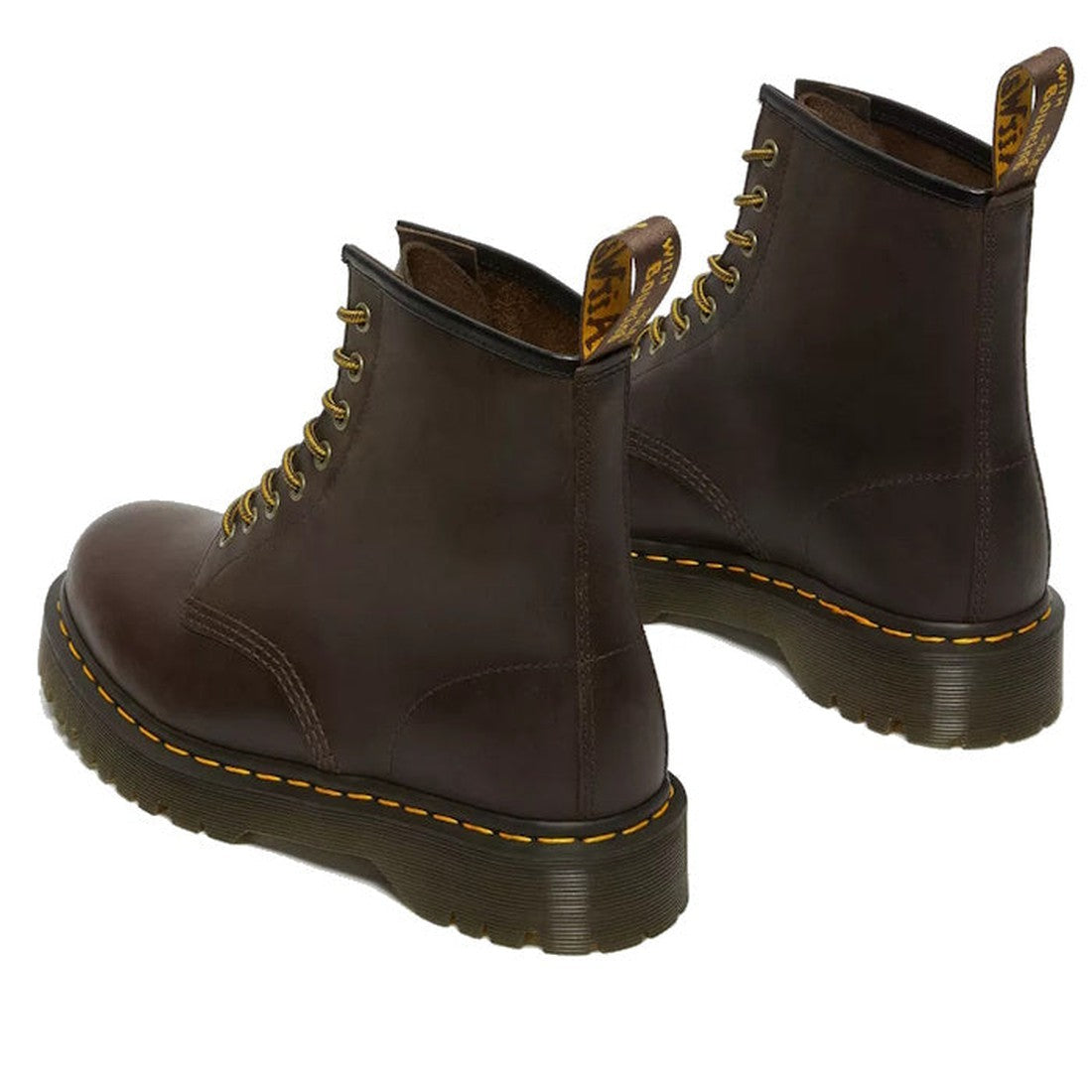 The Dr Martens - Bex 1460 8 Up Leather Crazy Horse Brown boots, with yellow stitching on the Bex sole and a yellow pull tab, are angled on a white background., 32000, 190665498615, 190665498622, 190665498639, 32004, 190665498653, 32006, 32007