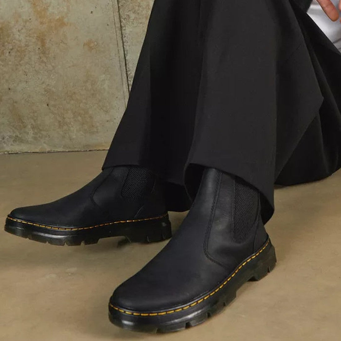 A person sitting on the ground showing the DR Martens Embury pull on chelsea boot in black with sole yellow stitching around the sole which you cannot see top down
190665358766,
190665358773,
190665358780,
190665358803,
190665358810,
190665358827,
1906653