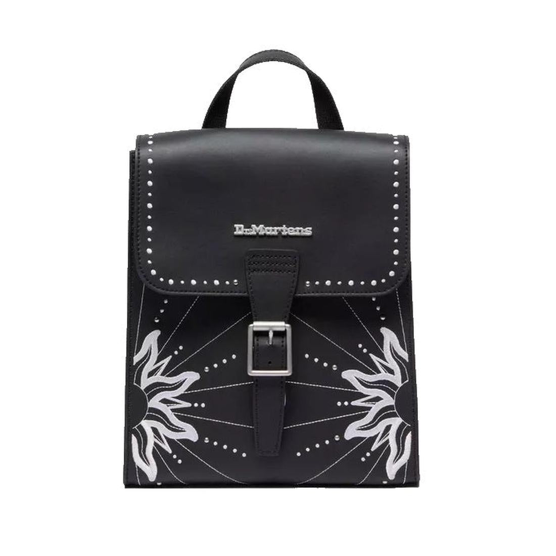 The Dr. Martens Mini Genix Nappa Solar Flare Leather Backpack in black features a top handle, buckle closure, silver studs, a white sunburst front design, and the brand logo on the flap., 190665739695