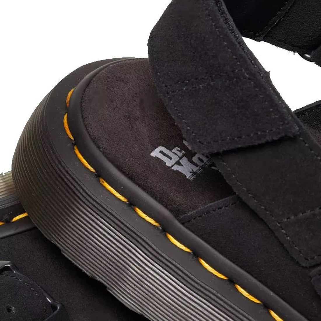 Close-up of the Dr Martens Black Jorge II Black Suede Sling Back Sandal Mule, featuring thick suede straps, yellow stitching, a textured black sole, Goodyear-welted construction, and the Dr. Martens logo on the footbed., 190665645477, 190665645484, 190665