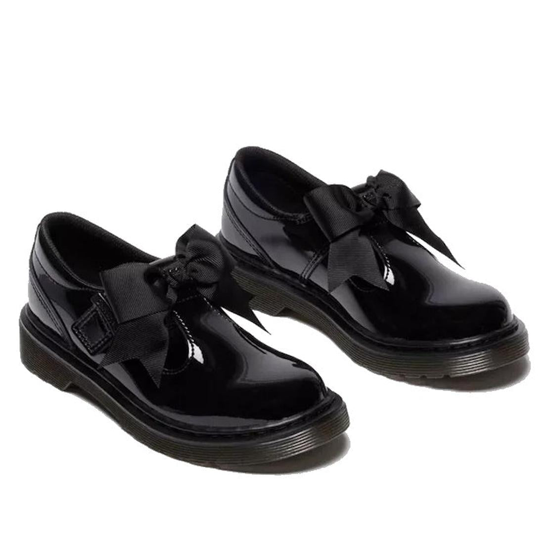 Pair of black DR Martens kids Polley showing the right outer side and front view and the left inner side and front shoes with bows on a white background.,
190665761818,
190665761832,
190665761856,
190665761863,
190665761764,
190665761788,
190665761801,, 1
