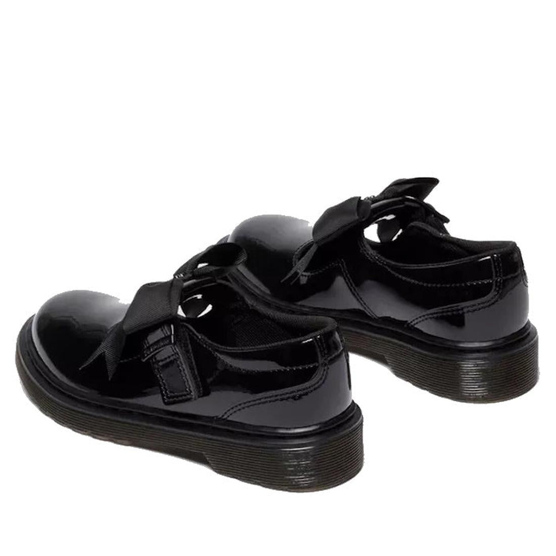 A heel, rear shot of a pair of Black Kids Polley Dr Martens  glossy shoes with buckles  that are velcro fstening on a white background.,
190665761818,
190665761832,
190665761856,
190665761863,
190665761764,
190665761788,
190665761801,, 190665761818, 19066