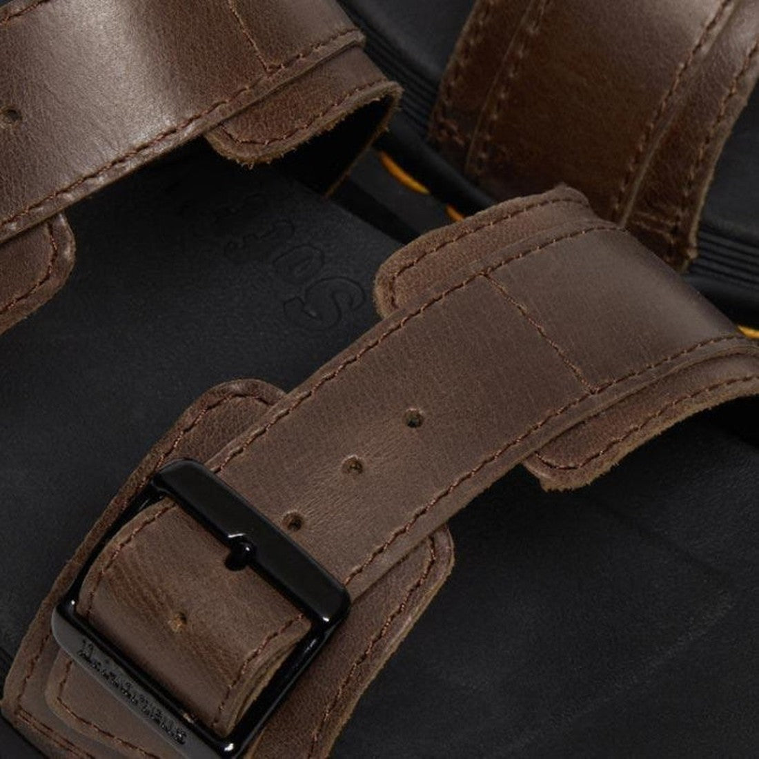 Close-up of Dr Martens Myles Dark Brown Oiled Illusion Sandal, featuring adjustable buckle straps with black metal buckles on a lightweight ripple sole. The Goodyear-welted stitching and rich leather texture are clearly visible., 26562, 190665523188, 1906