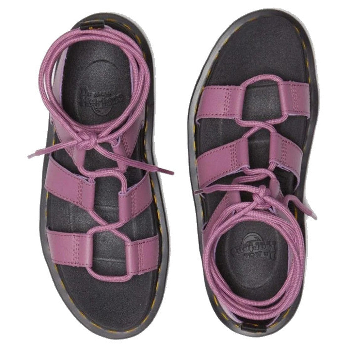 A pair of Dr Martens Nartilla Gladiator Sandal Mauve Pink Athena, featuring thick purple straps, laces, open-toe design, circular cutouts, and a lightweight Zebrilus sole—shown from above.