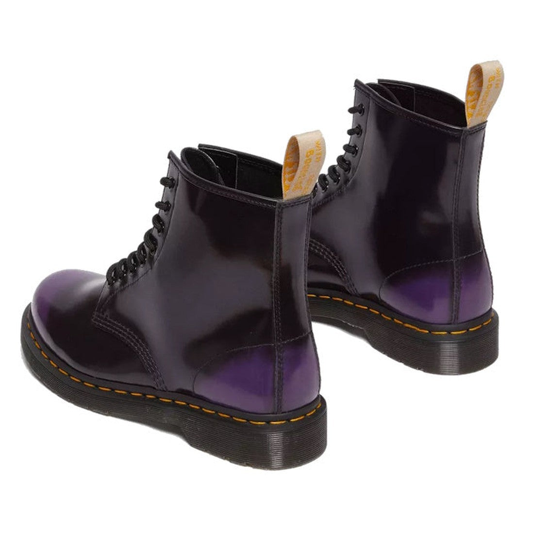A pair of Dr Martens Vegan 1460 Rich Purple Oxford Rub Off Boots with black soles, yellow stitching, and yellow pull tabs at the back, made from synthetic leather and shown from a rear-side angle., 190665602845, 31837, 31838, 31839, 190665602852, 19066560