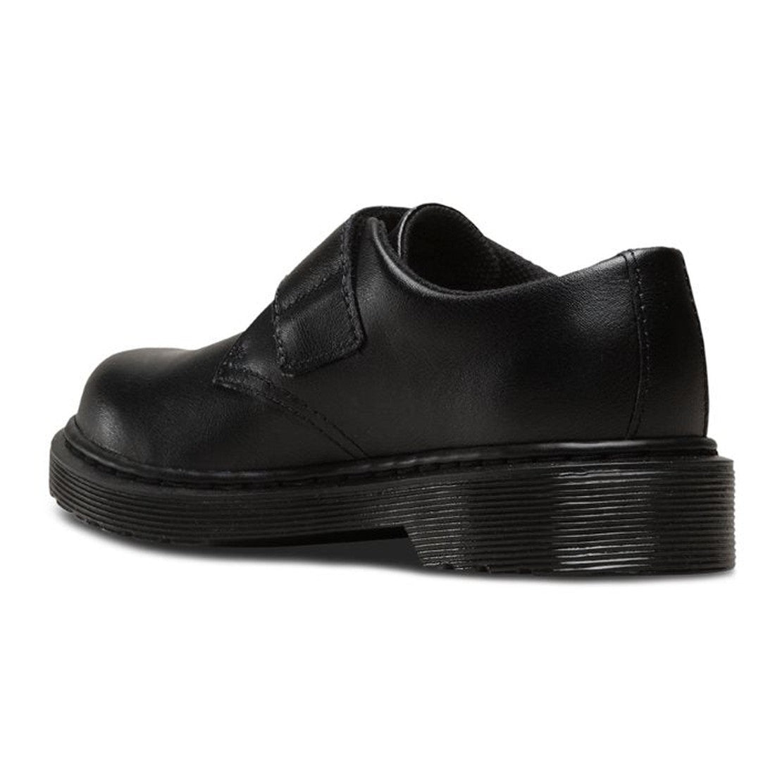The Dr Martens Kids Kamron II Mono Velcro Junior Black School Shoe (UK10-3) features a durable leather upper, thick textured sole, and Velcro strap—ideal for stylish, functional black school shoes. Shown from the back-left angle., 190665681185, 1906656812
