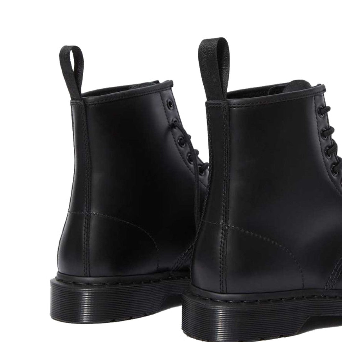 A close-up of the back and sides of two Dr Martens 1460 Black MONO 8 Up Boot Smooth, made from smooth black leather with visible stitching and thick air-cushioned soles., 883985396401, 883985396418, 883985396425, 883985396449, 883985396456, 883985396463, 