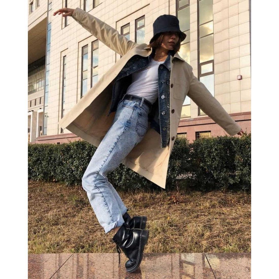 A woman in a coat, t-shirt and jeans on her tippy toes wearing a pair of dr martens 1460 boots.,
800090828511, 800090828535, 800090828542,800090828559.800090828566,800090796377,800090796391, 800090796384, 800090828511, 800090828535, 800090828559, 80009082